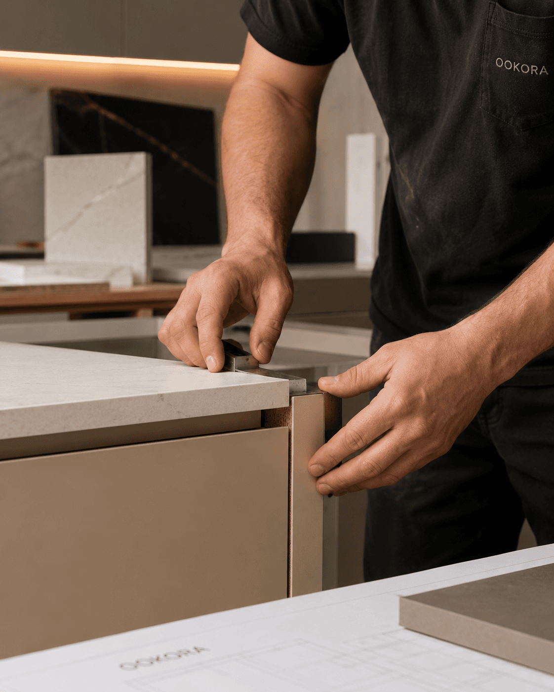 Workshop hands finishing the edge detail of a cabinetry piece.